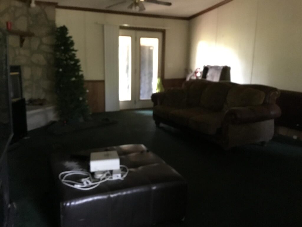 Picture our first home outdated living room with Christmas tree in July