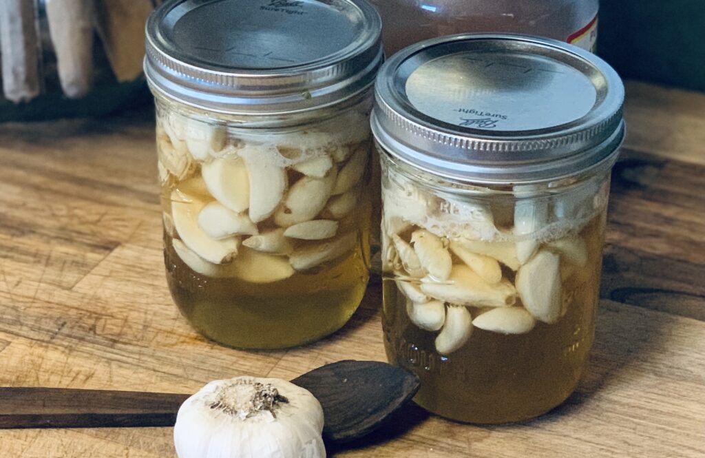 Two Pint sized Mason Jars of prepared Honey Fermented Garlic